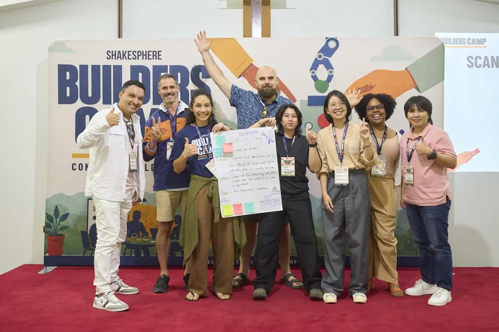 A Builders Camp team celebrating on stage